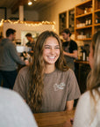 Woman wearing Proverbs 16:3 tee at coffee shop - CarryTheCross