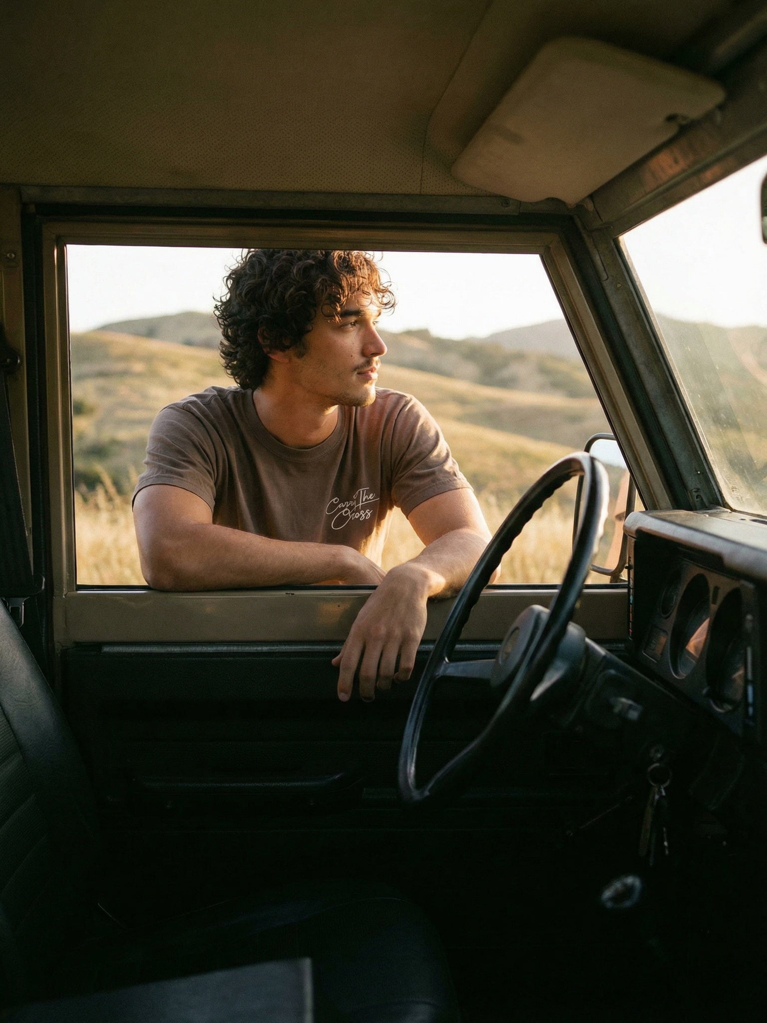 Man wearing Proverbs 16:3 tee in vintage truck - CarryTheCross