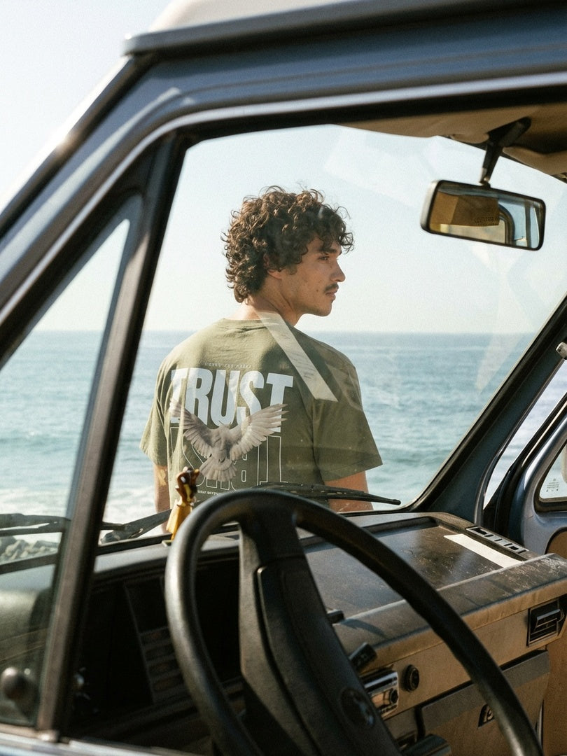 CTC approved original | pixels:d6ec6258e78cf7ee67e4903de9ab7bd394fa31b6f5f5958d8aa854b4de64bd77 | Trust Tee | source:curly_trust-tee_truck-beach.jpeg | side:back