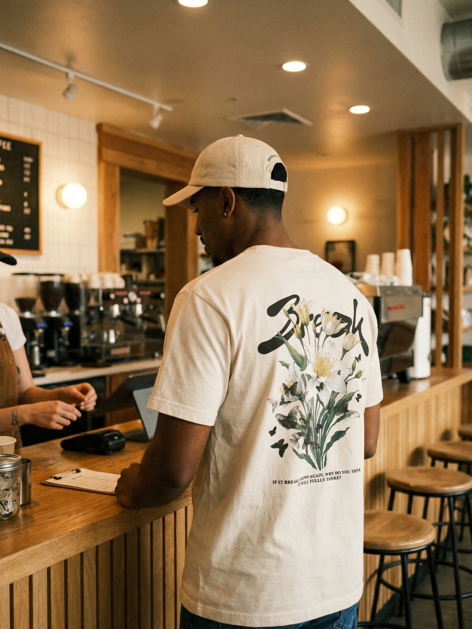 Man wearing Break tee at coffee counter - CarryTheCross Christian streetwear